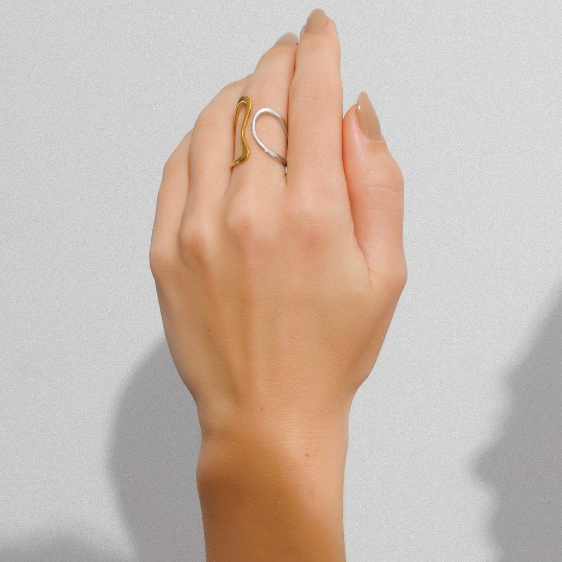 Adjustable contour ring with a mix of gold and silver plating.