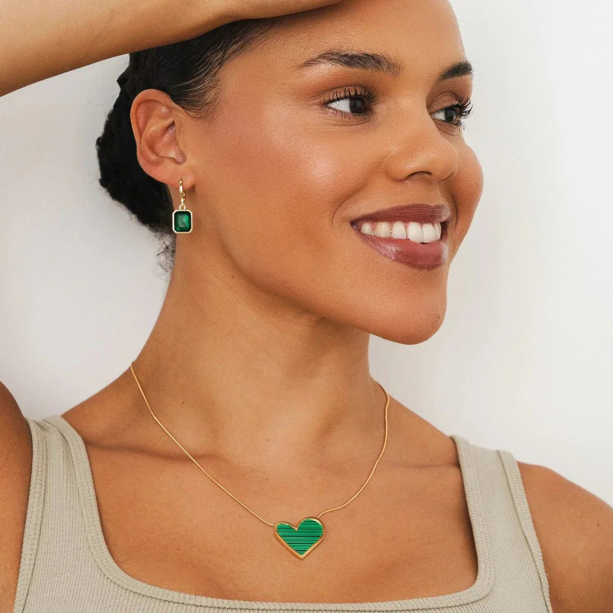 Small hoop earring with green crystal, 18k gold plated.